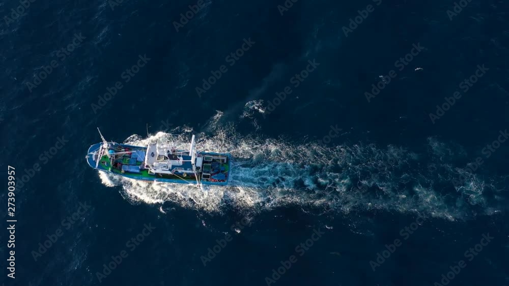 Top view of a fishing boat sailing in the Atlantic Ocean