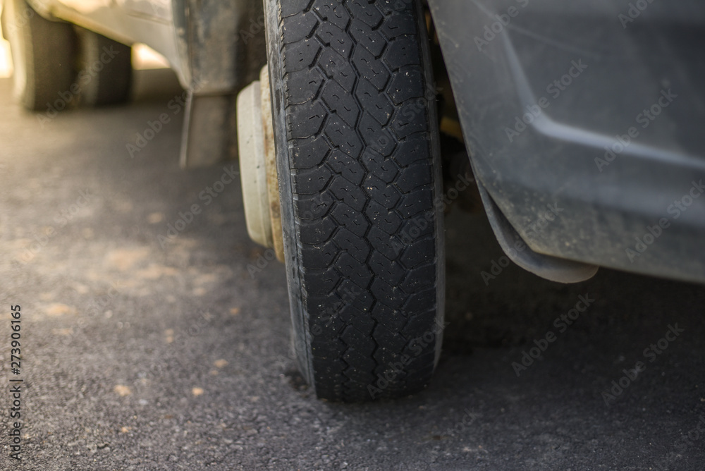 Close up view of car wheel.Transportation concept.wheel with summer tires close-up on background of road. The problem with Parking in the big city. Ecology in the city. Close up view of car wheel.Transportation concept.wheel with summer tires close-up on background of road. The problem with Parking in the big city. Ecology in the city.
