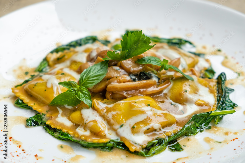 close up of home made porcini mushrooms ravioli with spinach close up of home made porcini mushrooms ravioli with spinach