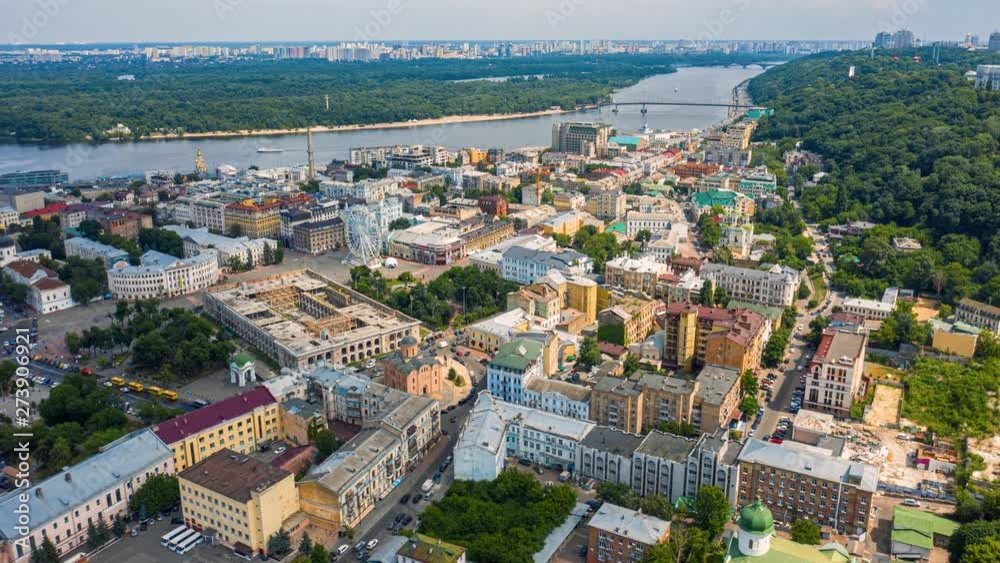 Fly over famous Kiev Podil district at summer. Kontractova square with rotating white ferris wheel. Aerial footage 4k Fly over famous Kiev Podil district at summer. Kontractova square with rotating white ferris wheel. Aerial footage 4k