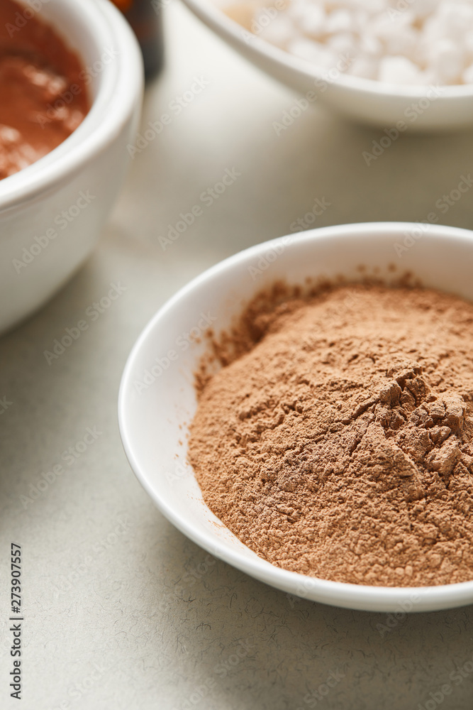close up view of brown clay powder in white bowl close up view of brown clay powder in white bowl