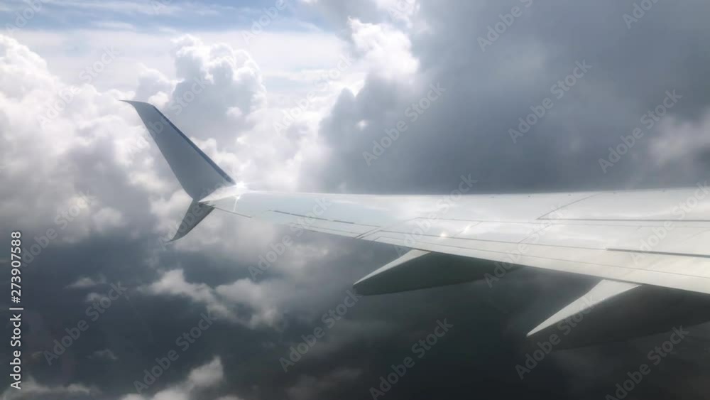 Airplane wing in the clouds. View from the window of the plane Airplane wing in the clouds. View from the window of the plane