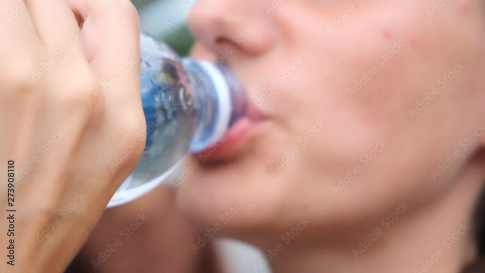 The Girl Drinks Water From A Bottle, close up. The Girl Drinks Water From A Bottle, close up.
