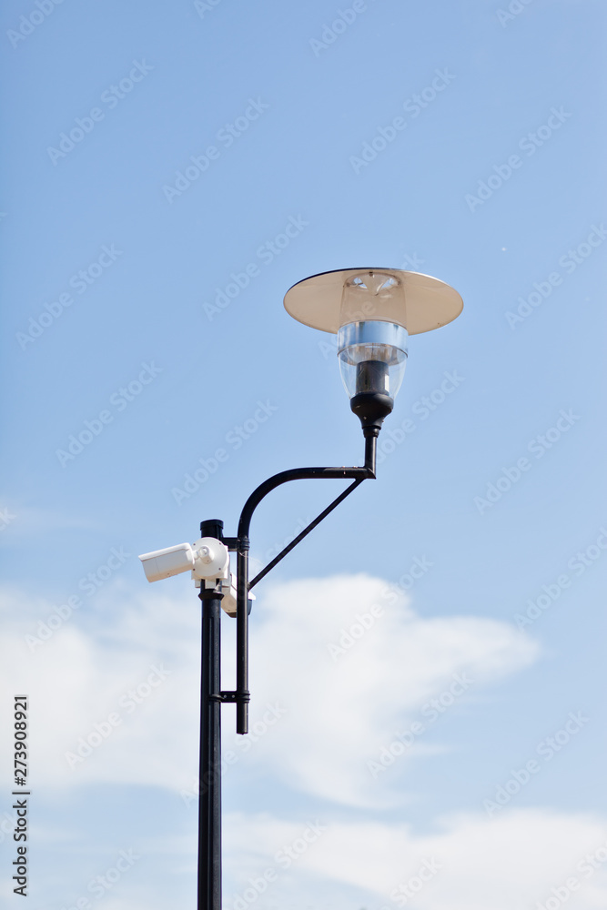 Lamppost on a cloudy sky background