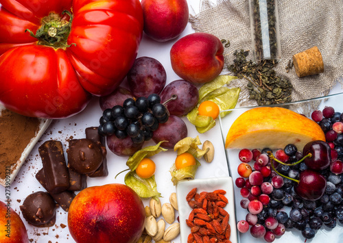 antioxidants, resveratrol food as green tea, grape, blueberry, apricot, apple, cocoa, tomatoes, pomegranate, physalis, dark chocolate, goji, nuts photo