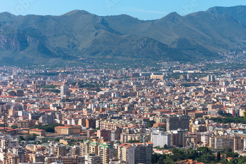 Aerial view from the height of the city in the valley of the hills of the mountains, many residential buildings.