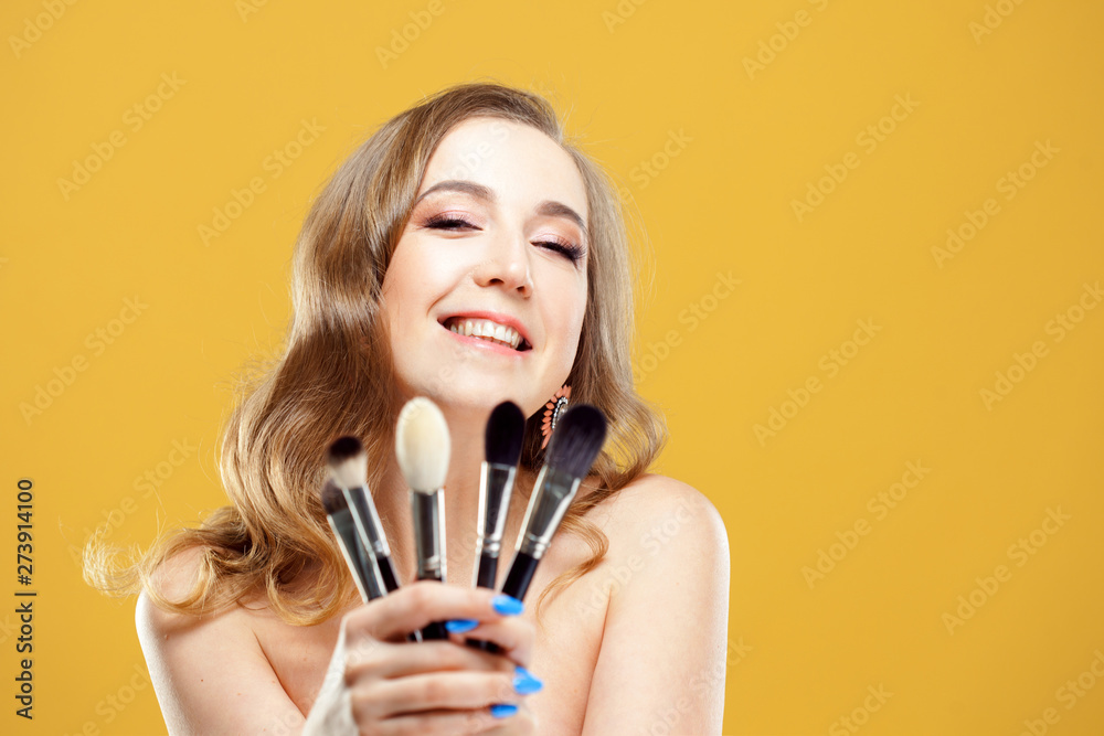 Beautiful young woman makeup artist with a set of professional makeup brushes Beautiful young woman makeup artist with a set of professional makeup brushes