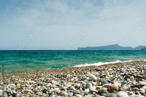 Pebble beach with sea waves. Travel concept. Selective focus