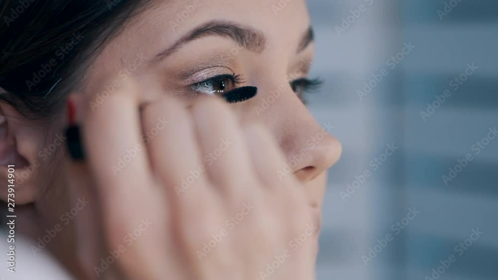 close up shot of make up artist apply false eyelashes close up shot of make up artist apply false eyelashes