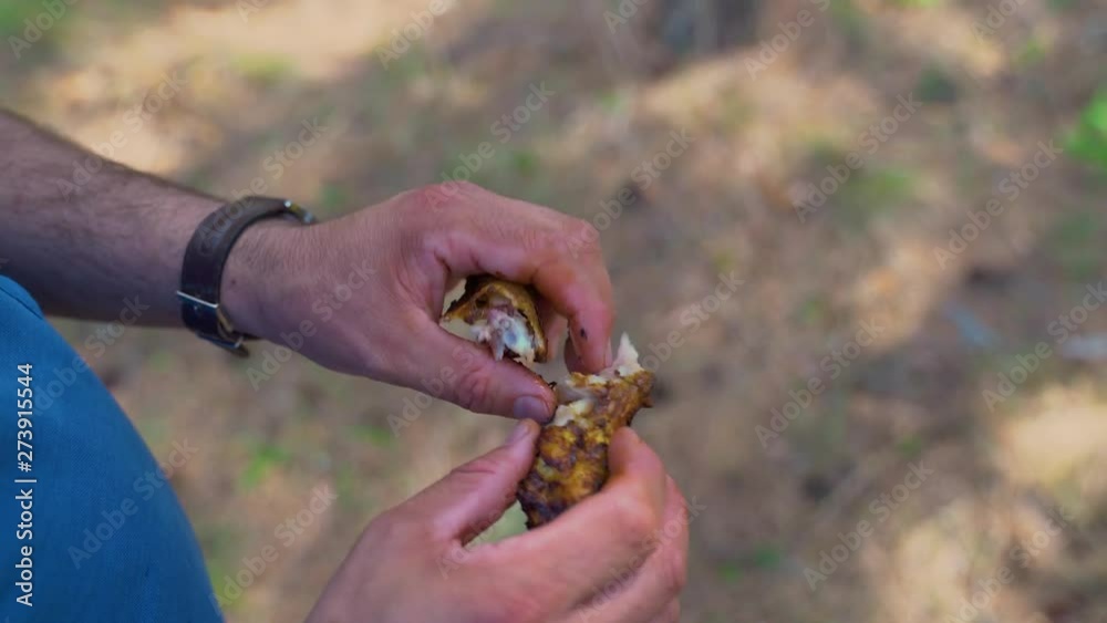tourist eating chicken wings. clouse-up