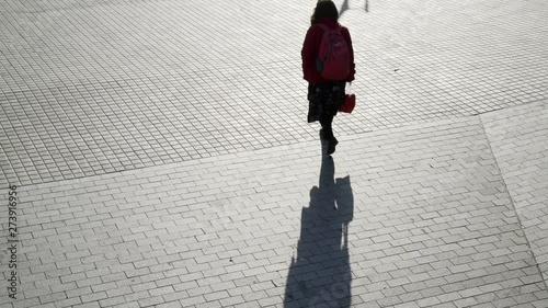 Black and white shadows moving from the metro. People walking silhouette in the morning light. Early hours in the city. Urban movements and creative background. Bricks on the street of Barcelona