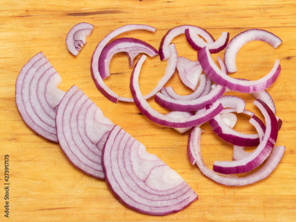 Sliced red onions on a wooden background