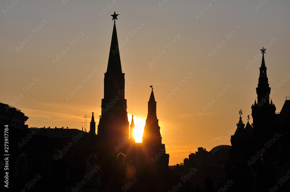Silhouettes of the towers of the Moscow Kremlin in the setting sun.