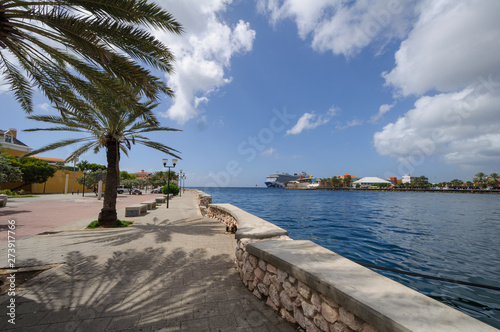 Waterfront coastal tropical city on the background of the Harbor and the blue sky with clouds.