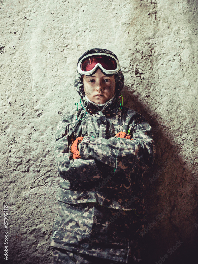 Little stalker girl in camouflage is hiding in a destroyed building. Photoset based on the game Chernobyl. Exclusion Zone. Nuclear post-apocalypse Little stalker girl in camouflage is hiding in a destroyed building. Photoset based on the game Chernobyl. Exclusion Zone. Nuclear post-apocalypse
