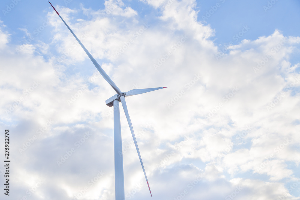 One wind turbine with cloudy sky in background One wind turbine with cloudy sky in background