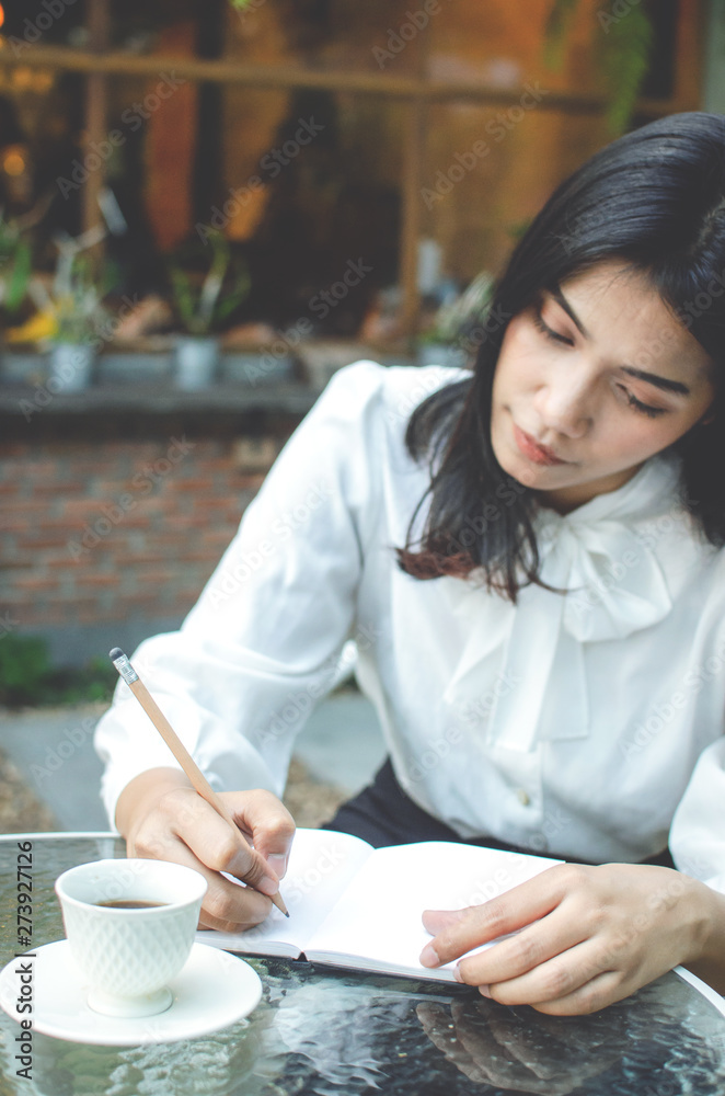 business woman in white shirt working in cafe business woman in white shirt working in cafe