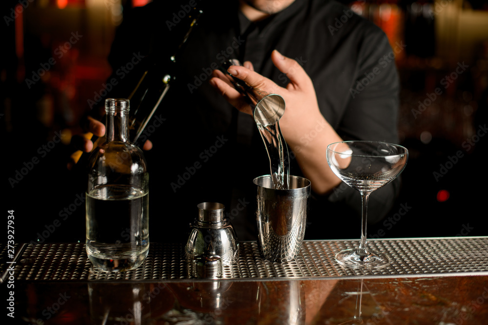 Close-up of pouring cocktail with a shaker