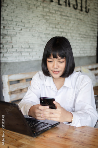 young woman using smart phone in cafe