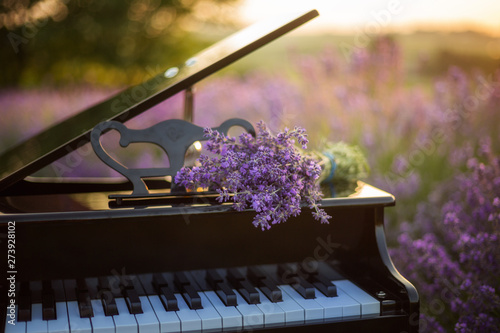  A bouquet of lavender lies on the of piano. Romantic spring backgroud