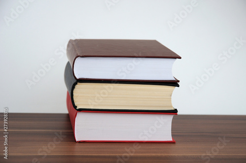A stack of books on a light background with a field for writing text or inscriptions