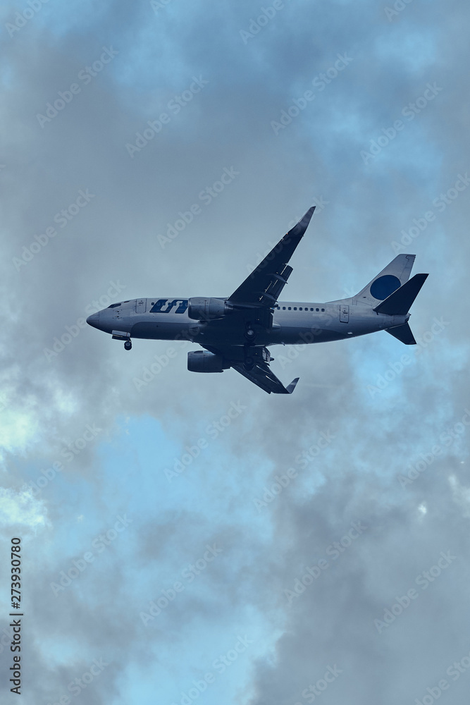 Aeroplane in the cloudy sky is flying from aeroport after summer rain. Aeroplane in the cloudy sky is flying from aeroport after summer rain.