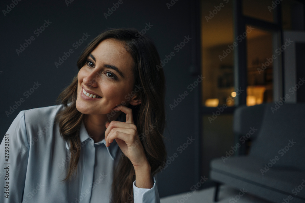 Portrait of smiling young businesswoman looking sideways