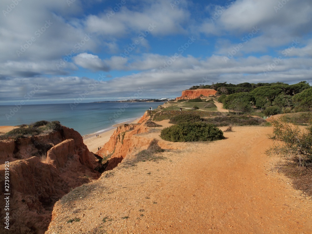 Red high cliffs at Praia da Falesia, a paradise beach in Albufeira in Portugal