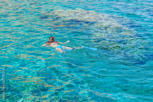 sexy girl swimming and snorkeling in Red sea beautiful aquamarine water exotic natural environment  enjoy in summer cruise vacation time concept picture with empty copy space for text