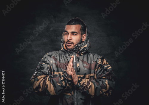 Black male dressed in a military jacket.