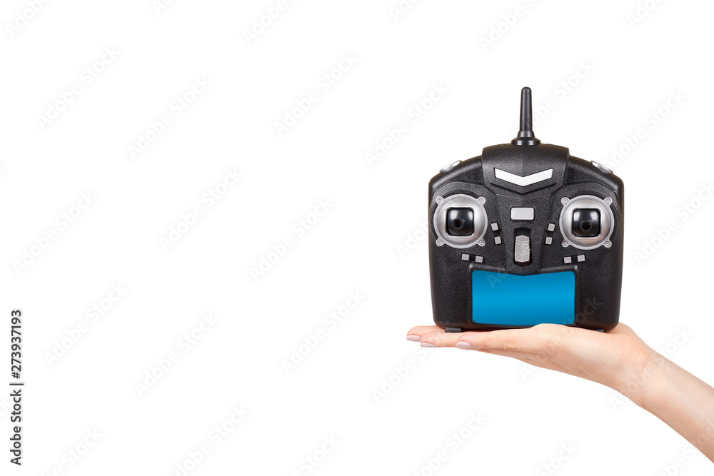 Hand with black remote control for drone, RC with antenna Hand with black remote control for drone, RC with antenna