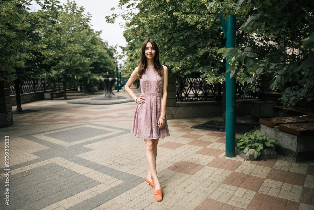 beautiful young girl in dress is resting outdoors, woman is walking on the street beautiful young girl in dress is resting outdoors, woman is walking on the street