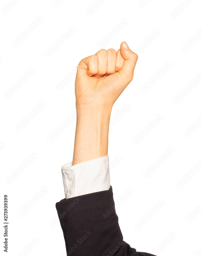 Female hand in business suit showing fist Female hand in business suit showing fist