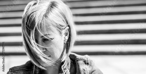 Portrait of a girl with short hair. Blonde in the city. Black and white photography