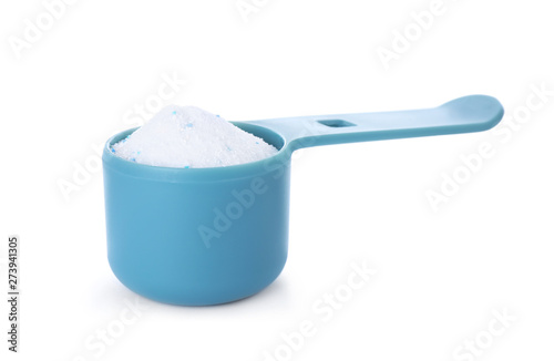 Laundry detergent in plastic measuring scoop on white background