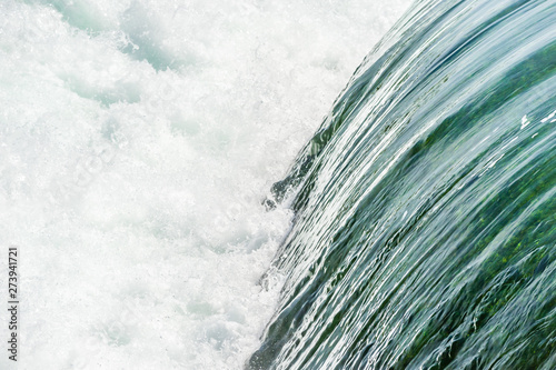 Smooth water falling into churning rapids.