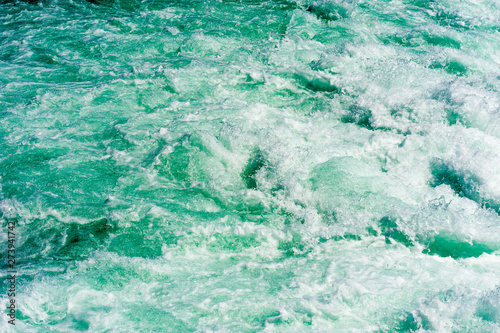 Abstract churning water and rapids in river.