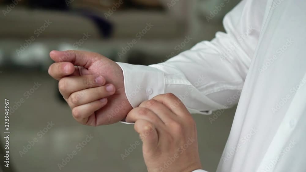 Man put on and buttoning white shirt Man put on and buttoning white shirt