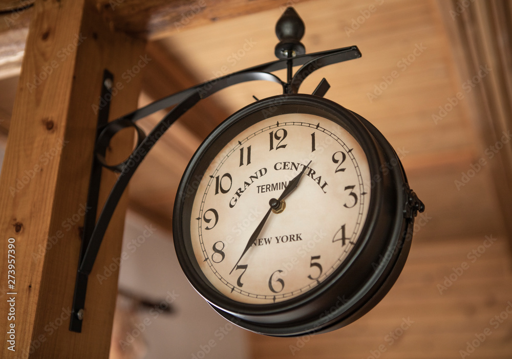 Naklejka premium Vintage wall clock. Old style hanging clock.