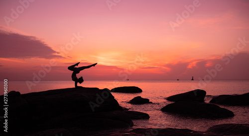 Asian girl practice Yoga on the beach Sunrise morning day © chayathon2000