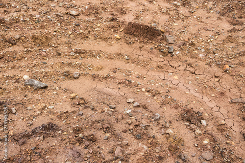 Colored silt stones and circle wheel prints on construction road