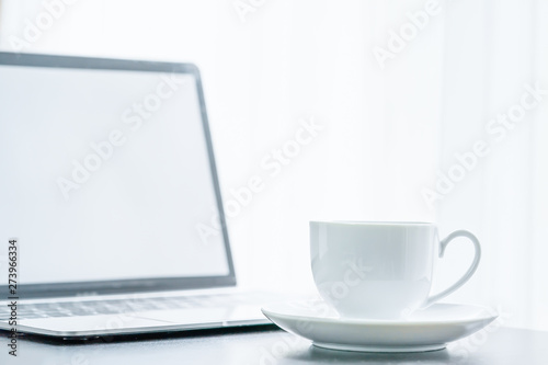 Close up laptop computer and coffee cup
