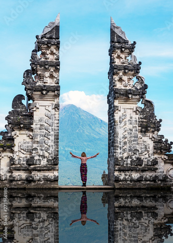 Unidentified person at the gate of Pura Penataran Lempuyang infront of Mt Agung Volcano in Bali Indonesia. photo