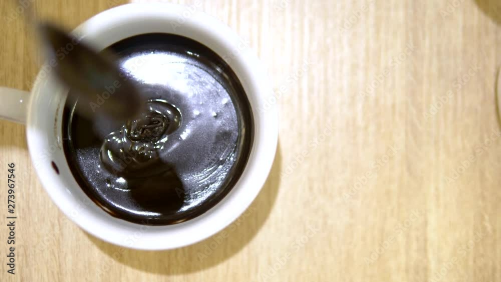 close-up. Liquid dripping chocolate from a spoon into the cup. hot chocolate in a cafe close-up. Liquid dripping chocolate from a spoon into the cup. hot chocolate in a cafe