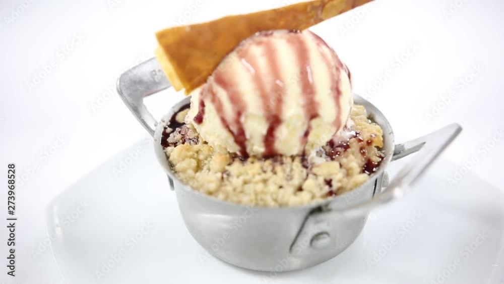 Berry cobbler with vanilla ice cream in small metal pot Berry cobbler with vanilla ice cream in small metal pot