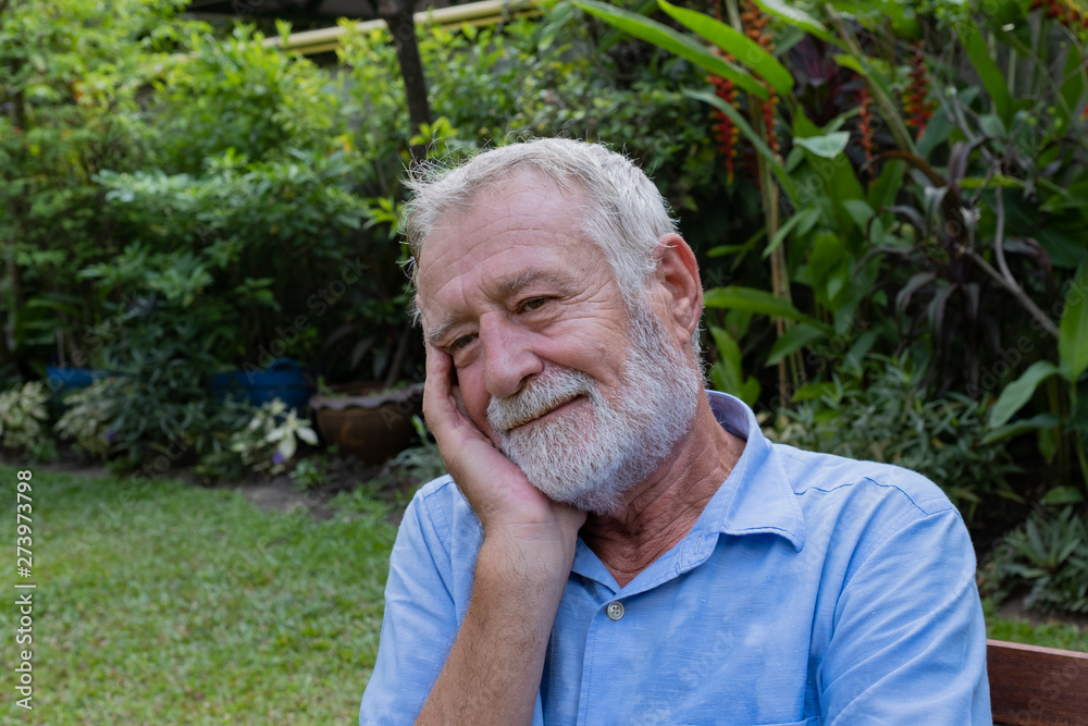 senior man sitting alone in the garden, and try to remember and thinking in the garden at nursing home senior man sitting alone in the garden, and try to remember and thinking in the garden at nursing home