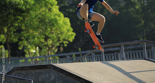 Skateboarder skateboarding on skate park