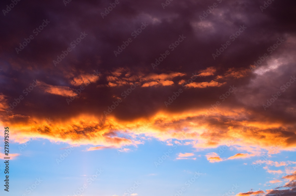 Colorful and Dramatic Sunset Storm Clouds in the Sky. Weather, Thunderstorm, Cloudscape Background.