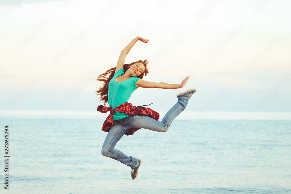 girl jumping by the sea