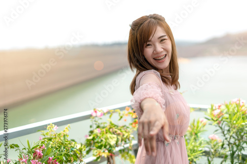 Asian women with beautiful brown hair look happy. Smiling and cheerful In the midst of nature.